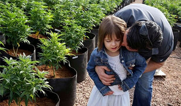 Parent and child in a hemp field
